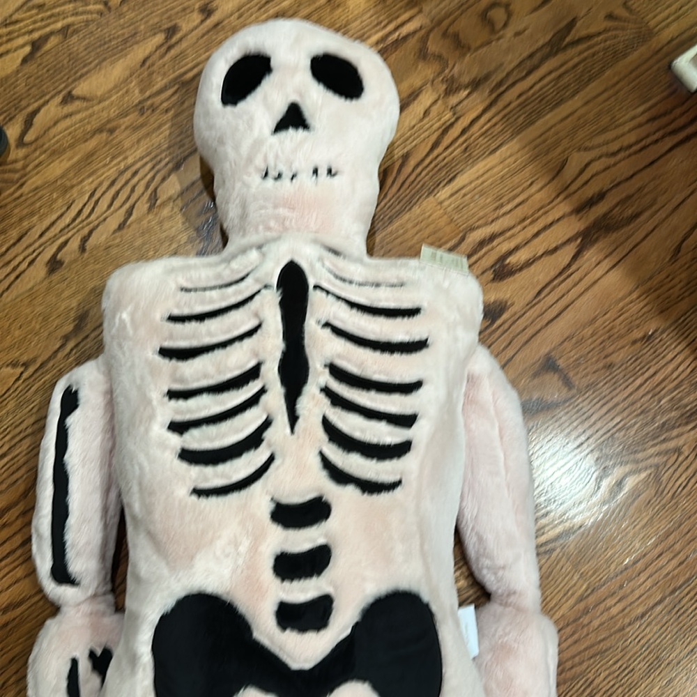 Giant pink faux fur  and black skeleton pillow